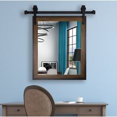 a mirror hanging on the wall above a desk