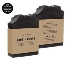 two black soap bars sitting next to each other on top of a cardboard box with the words mint and clove