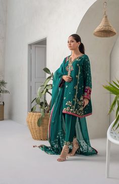 Same color co-Ord sets are in for the season. Stand out in this pepper green cotton net box cut kurta, embellished and worked with kamdani. The matching raw silk trousers have worked detailing. The organza dupatta is finished with kamdani detailing in starry details. Green Silk Palazzo Set With Mirror Work, Festive Green Palazzo Set With Mirror Work, Green Semi-stitched Cotton Silk Sharara, Green Tissue Silk Palazzo Set For Eid, Green Chikankari Embroidery Cotton Silk Palazzo Set, Green Cotton Silk Palazzo Set With Chikankari Embroidery, Green Cotton Silk Sharara With Straight Kurta, Green Silk Kurta With Sheer Dupatta, Green Palazzo Set With Mirror Work For Eid