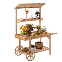 a wooden cart with flowers and plants on it