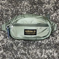 New Adidas Originals National Waist Pack / Crossbody Color: Major, Black, Gold ( Army, Military Green ) Size: Os *Unisex* *Ships Same Day Or Next!!!! *Please Feel Free To Ask Any Questions!!!! Product Details Fabric Type 100% Polyester Care Instructions Hand Wash Only Origin Imported Country Of Origin Indonesia About This Item Branding In Front. Zippered Main Compartment And Small Front Pocket. Key Fob In Front Pocket. Clip-Lock Closure. Metal Pullers. Description Worn Across Your Body Or Around Casual Streetwear Bags With Pockets, Green Zipper Closure Bag For Streetwear, Casual Nylon Bags For Streetwear, Everyday Adidas Nylon Bag, Casual Green Sports Bag, Casual Streetwear Bag With Zipper Closure, Urban Green Nylon Bag, Green Sports Bag With Pockets, Functional Green Bags For Streetwear