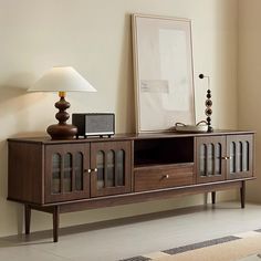 a wooden entertainment center with glass doors on the front and sides, in a living room