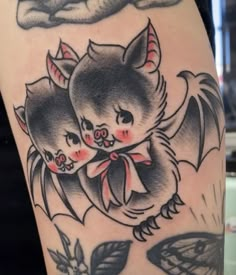 a tattoo with two cats on it