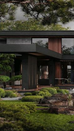 a modern house surrounded by trees and rocks