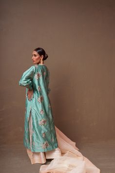 A ferozi colored, raw silk shirt with floral hand-embroidery and a net, organza pearl white dupatta and raw silk ajar pants.3-Piece SuitReady to wear Tissue Silk Sets With Floral Embroidery For Reception, Designer Raw Silk Sharara With Floral Embroidery, Floral Embroidered Tissue Silk Designer Wear Set, Designer Tissue Silk Set With Floral Embroidery, Floral Embroidery Tissue Silk Set For Designer Wear, Spring Raw Silk Palazzo Set With Straight Kurta, Spring Tissue Silk Kurta With Resham Embroidery, Spring Palazzo Set In Raw Silk With Straight Kurta, Designer Tussar Silk Palazzo Set With Sheer Dupatta