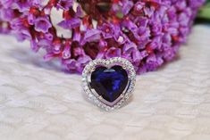 Make a statement of love and elegance with this stunning Heart-Shaped Sapphire Blue CZ Ring. The dazzling deep blue heart-shaped stone is encircled by brilliant cubic zirconia, all set in high-quality sterling silver. This eye-catching ring is perfect for special occasions or adding a touch of romance to your everyday style. Whether as a thoughtful gift or a treat for yourself, this ring exudes luxury and charm. 💙 Sapphire blue heart-shaped CZ stone for a bold, romantic touch ✨ Cubic zirconia a Heart Shaped Sapphire Rings For Formal Occasions, Blue Rings For Valentine's Day Formal Occasion, Blue Jewelry For Valentine's Day Party, Elegant Heart Shaped Rings For Parties, Sapphire Jewelry For Valentine's Day Formal, Blue Jewelry For Anniversary On Valentine's Day, Elegant Jewelry With Lab-created Sapphire For Valentine's Day, Elegant Heart-shaped Rings For Party, Blue Heart Cut Jewelry For Formal Occasions