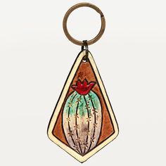 a wooden keychain with an image of a cactus on it's side