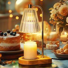 a table topped with cake next to a lit candle