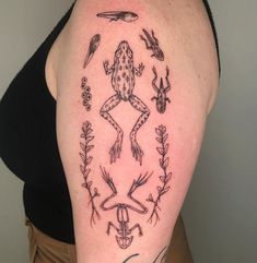 a woman with a tattoo on her arm has an image of a frog and birds