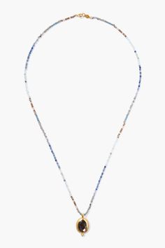 Alternating rows of blue toned gems and crystals create a beautiful ombré pattern in this vibrant beaded necklace with a shimmering gold framed hypersthene pendant.18k gold plated sterling silver, iolite, lapis, sodalite, blue topaz, labradorite, hypersthene, crystals.22" in length.Handmade in Vietnam. Blue Gem Necklace, Necklace Charms, Pearl Necklace Earrings, Gem Necklace, Handmade Box, Gems And Crystals, Blue Gems, Beaded Top, Necklace Blue