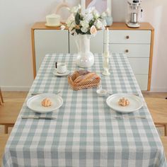 the table is set with plates and cups