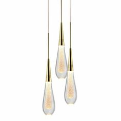 three light fixtures hanging from the ceiling with white and gold colored glass tear shaped lights