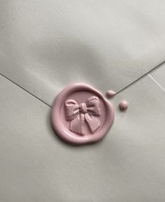 a wax stamp with a bow on it