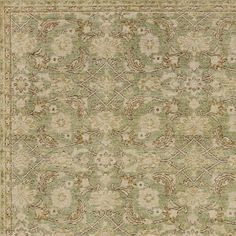 an area rug with green and beige colors