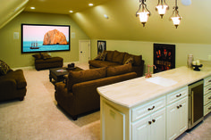 a living room filled with furniture and a flat screen tv mounted to the wall above it