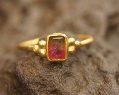 watermelon tourmaline ring, 24k gold ring, 24k gold ring, unique engagement ring, 24k gold gem ring, gold artisan engagement ring, statement ring I love watermelon tourmaline and with this delicate 24k gold setting , it's a refreshing stone breathtaking piece. stone is 6X4.5 mm  watermelon tourmaline I used 24k gold for the setting,  and 22k for the rest of the wire ring (1.4 mm) Please view my full collection of earrings:  https://www.etsy.com/geffenjewelry The jewelry will be packed in a gift Watermelon Tourmaline Engagement Ring, Gold Ring Unique, Watermelon Tourmaline Ring, Bezel Earrings, Wire Ring, Unique Engagement Ring, Dope Jewelry, Gem Ring, 18k Gold Ring