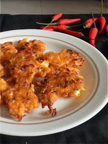 some food is on a white plate with red peppers