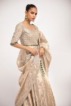 Sumira – Sania Maskatiya International Bollywood Style Hand Embellished Gown For Eid, Embellished Raw Silk Traditional Wear For Eid, Transitional Tissue Silk Sharara For Reception, Floor-length Raw Silk Sharara With Resham Embroidery, Transitional Silk Dupatta With Mirror Work, Embellished Raw Silk Sharara For Reception, Hand Embellished Anarkali Set For Reception At Eid, Festive Silver Dress With Mirror Work, Eid Embellished Silk Lehenga