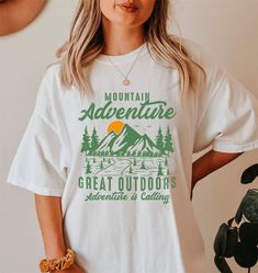 Adventure Shirt, Travel Shirt, Hiking Shirt, Desert Shirt, Explore Shirt, Mountain Shirt, Camping Shirt Tee, Nature Lover Gifts, Road Trip shirt We are delighted to see you here! Visit our main page to explore more design options! We are sure you will love our designs! Please feel free to message me if you have any questions or requests. I'll get back to you as soon as possible. 👉For oversized fit go one sizes up your normal size 👉Our Unisex T-Shirt brand is Comfort Colors® 1717 👉HOW TO ORDER T-SHIRT. 1- Please check all of the listing images. 2- Select your Shirt size from selection box. 3- Select your Shirt color from the selection box. 4- Select the quantity. 5- Go to add to cart. 🕕Production Time 1-2 business days🕕 -Standart Shipping 2-5 business days after production time. -Print White Cotton T-shirt For Camping, White Relaxed Fit T-shirt For Outdoor Activities, White Summer Adventure Shirt, White Summer T-shirt For Adventure, White Letter Print Top For Outdoor Activities, Casual White Tops For Adventure, White Relaxed Fit T-shirt For Outdoor, Green Graphic Print Outdoor Shirt, White Graphic Print Shirt For Camping