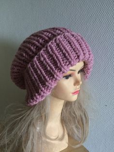 a mannequin head wearing a purple knitted hat