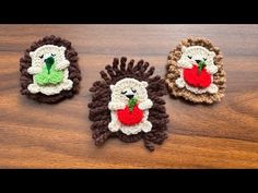 three crocheted hedges sitting on top of a wooden table