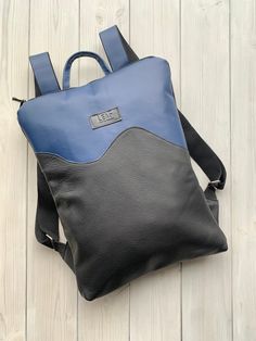 "Blue Leather Backpack, One Of A Kind Backpack Up-cycled blue leather backpack. Unique and one of a kind, you won't find anyone with the same backpack. Zip it and you will find natural lining with open and zipped pocket inside. LeaF leather backpacks are very light and not overloads your back.  Minimalist design leather backpack fits 15\" laptop. Size - 32x42 cm You can choose backpack plus leather purse. Pouch is perfect for your cosmetics, laptop charger or to use it as evening bag. It is made Blue Leather Backpack For Everyday Use, Modern Blue Leather Backpack For Everyday, Modern Everyday Blue Leather Backpack, Blue Satchel Leather Backpack For On-the-go, Blue Leather Satchel Backpack For On-the-go, Modern Blue Leather Backpack For Travel, Modern Blue Leather Backpack With Adjustable Strap, Blue Leather Satchel Backpack, Blue Satchel Backpack