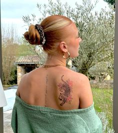 a woman with a tattoo on her back