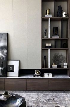 a living room filled with furniture and bookshelves next to a painting on the wall