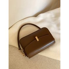 A shoulder bag with a square body and a flap that can hold a smartphone and a small wallet. The golden clasp and small design give it an elegant and stylish impression. It is also possible to remove the shoulder strap. 
 
 
 Color 
 
 Dark brown 
 Black 
 
 
 Size 
 
 
 FREE size 
 
 Height: 14cm 
 Width: 22cm 
 Depth: 6.5cm 
 
 
 
 
 
 Material 
 
 Leather Brown Flap Bag With Mobile Phone Pocket For Office, Brown Office Flap Bag With Mobile Phone Pocket, Evening Brown Baguette Bag With Adjustable Strap, Trendy Brown Rectangular Phone Bag, Chic Square Phone Bag For Everyday Use, Brown Flap Bag With Detachable Strap For Office, Elegant Brown Box Bag With Detachable Handle, Classic Gold Flap Bag With Detachable Handle, Brown Phone Bag For Office