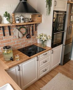 a stove top oven sitting inside of a kitchen next to a wall mounted oven range