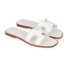 This pair of Oran Sandals are in white box leather with contrast stitching and feature the iconic H crossover strap. Origin: ItalyCondition: Pristine; new or never Accompanied by: Hermes box, dustbags, carebook and ribbonSize: 38 EU Hermes Oran Sandals, Hermes Oran, Hermes Box, Sandals White, White Sandals, White Box, Contrast Stitch, Dream Wardrobe, Crossover