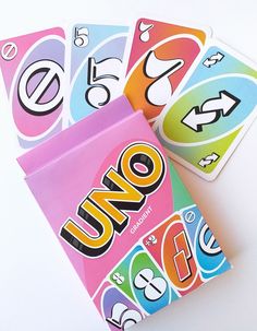 four uno cards are sitting next to each other on a white surface, with the word uno printed on them