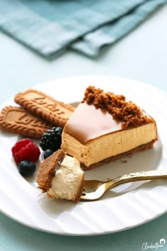 a piece of cheesecake on a plate with berries and crackers