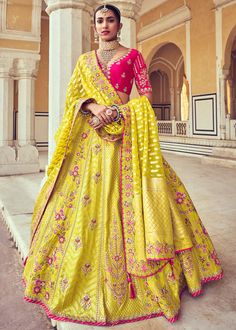 Woven Zari Banarasi silk lehenga choli in Yellow and Pink 6002 Desc:  Style : A-Line Lehenga Choli Color : Yellow and Pink Fabric : Silk   Work : Heavy Jacquard Woven With Embroidery & Stone Work Wash Care : Dry clean Sleeve Style : Half Sleeve Long Sleeves : Done only in Custom Stitch Sleeves Lining : Done only in Custom Stitch Bust Size : 32 to 42 Inches Occasion : Wedding   Mehendi   Sangeet   Engagement   Reception   Ceremonial   Baby ShowerShop Banarasi lehenga,silk lehengas,h Yellow Lehenga Designs, Haldi Outfits For Brides, Lemon Yellow Lehenga, Sangeet Jewellery, Bandhani Suit, India Outfits, My Daughter Quotes, Ghaghra Choli, Mirror Work Lehenga