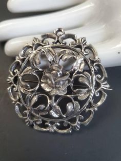 "This is a lovely and rare antique brooch. Highly detailed openwork design with a center open rose. It is sterling silver (tested) unmarked. Hook closure. In very good, antique condition. 1.75\"  x  1.75\"" Vintage Silver Jewelry With Roses, Vintage Rose Brooch Jewelry, Vintage Rose Jewelry With Brooch, Vintage Rose Brooch, Antique Jewelry Rare, Open Rose, Bold Art, Sterling Silver Brooch, Antique Brooches