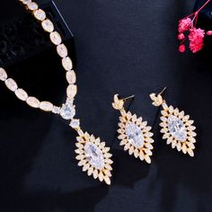 A beautiful bridal jewelry set that will add elegance and sophistication to any wedding gown or formal ensemble! Adorned with intricately faceted cubic zirconia that capture the light from every angle with a perfectly translucent appeal, the pieces are platinum / 14K yellow gold plated for a flawless finish which enhances the intricate detailing and conveys a modern take on old elegance. Necklace: 16.5" (approx. 42cm) long with a secure fold-over closure (if longer is needed, a 2" extension chai Gold Crystal Jewelry Set With Matching Earrings, Gold Necklace Wedding, Shine Jewelry, Beautiful Bridal Jewelry, Brides Dress, Wedding Dress Jewelry, Wedding Necklace Set, Necklace Luxury, Bridal Necklace Set