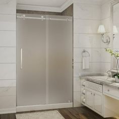 a bathroom with a sink, mirror and shower stall in the middle of the room