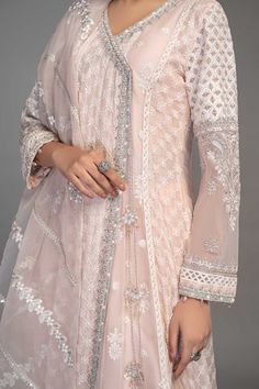 Light Pink Embroidered Anghrakha Style Pakistani Party Wear Frock embrace tradition in this gorgeous white ensemble with sequin and tilla motif details and delicate iconic flare. The angrakha is adorned with sequin sheets with thread outlines. Detailed Description: SKU: PB928 Detailing: Embroidery, Threads, Motifs, Dabka Color: Light Pink Fabric: Raw silk, Organza Design: Fully Embellished Dress with Embroidery Event: Party wear, Festive White Mirror Work Kurta For Diwali, White Kurta With Mirror Work For Diwali, Festive White Kurta With Mirror Work, Diwali White Kurta With Mirror Work, Festive White Anarkali Set, White Semi-stitched Anarkali Set For Designer Wear, Designer White Sharara With Dupatta, White Semi-stitched Anarkali Set For Transitional Season, White Traditional Wear With Mirror Work For Transition Season