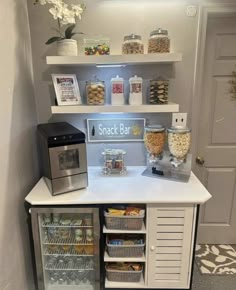 a small snack bar with lots of snacks on it's shelves and an icebox