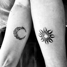 two people with matching tattoos on their arms, one has a sun and the other has a moon