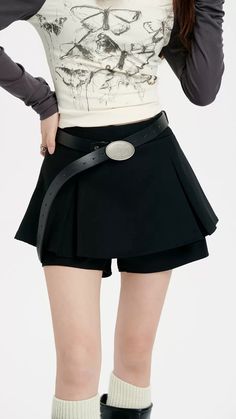 Revamp your wardrobe with the timeless chic of our Pleated Mini Skirt featuring an eye-catching oversized belt detail. This mini skirt channels a blend of sophistication and playful charm with its high-waisted A-line silhouette and crisp pleating. Crafted from a mix of polyester and viscose fibers, it provides both comfort and a flattering drape. The solid color and retro vibe make it a versatile piece for a multitude of settings, from casual outings to more formal affairs. Style this skirt with Elegant Belted Short Skort, Elegant Mini Pleated Skirt With Belt Loops, Elegant Mini Skirt With Belt Detail, Elegant Short Length Belted Skort, Relaxed Fit Belted Pleated Skirt, Summer High-waist Belted Skort, Summer High Waist Belted Skort, Elegant Belted Skort, Chic Belted Skort For Night Out