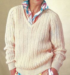 an older woman wearing a white sweater and colorful pants