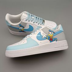 Elevate your sneaker game with the Nike Air Force 1 Character Duck Blue Custom. This one-of-a-kind shoe features a unique duck blue colorway and custom detailing for a truly stand-out look. With the iconic Air Force 1 design and Nike's top-notch quality, these sneakers are sure to provide both style and comfort. Step up your street style with these statement kicks. ★ Brand new with box ★ Each pair is unique and one of a kind ★ Each pair is personally handmade, painted with high quality Angelus. Customizable Blue Lace-up Sneakers, Blue Customizable Sporty Sneakers, Sporty Customizable Blue Sneakers, Customizable Sporty Blue Sneakers, Blue Casual Custom Sneakers, Custom Blue Sneakers, Custom Blue Low-top Sneakers, Custom Blue Sneakers For Sports, Custom Blue Sports Sneakers