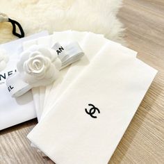 three pieces of white cloth with black and white flowers on them sitting next to each other