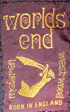 a red cloth with gold lettering on the front and back of it that says, wolplos end born in england