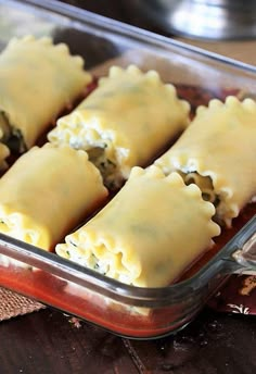 some ravioli in a glass dish on a wooden table