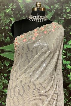 This Saree is Ready to Wear Add a touch of elegance to your party attire with this Gray Georgette Saree. Featuring stunning floral sequins, this saree is sure to make a statement. Its lightweight and flowing fabric make it comfortable to wear, perfect for any occasion. Upgrade your wardrobe today with this elegant saree. (With Fall and Pico Done) Fabric Details Blouse: GeorgetteSaree: GeorgetteBlouse Piece Length: 85cm meterSaree Length: 5.7 meter Elegant Wedding Sequin Fabric With Resham Embroidery, Unstitched Organza Blouse Piece For Wedding, Wedding Unstitched Organza Blouse Piece, Silver Resham Embroidery Party Dress, Silver Dress With Resham Embroidery For Party, Fitted Pre-draped Saree With Zari Work For Wedding, Silver Party Wear Dresses For Festive Occasions, Floor-length Pre-draped Saree With Self Design For Party, Sequin Organza Saree For Wedding