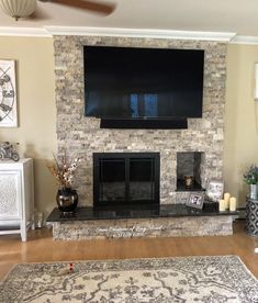 a large flat screen tv mounted above a fireplace