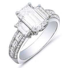 A fascinating diamond ring that will bring years of memories. The center diamond is a gorgeous emerald cut diamond. The diamond has a weight of 2.00 carats. The clarity ranges from VS1 with a color grade of G. Additional side diamond contains 0.50 Ct. of baguette cut diamonds complimenting the center stone, 0.50 Ct. of baguette cut diamonds flowing down the shank as channel set, and 0.30 ct. Round brilliant cut diamonds set as micro pave. split Metal : Available in 14K Gold, 18K Gold or Platinum Ring Types, 3 Stone Diamond Ring, Baguette Engagement Ring, Emerald Cut Diamond Engagement Ring, Emerald Cut Diamond Engagement, Emerald Cut Diamond Ring, Emerald Cut Engagement, Emerald Engagement Ring Cut, Emerald Cut Diamond