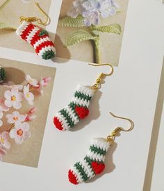 crocheted christmas stocking earrings are displayed in three different pictures, one is green and the other is red